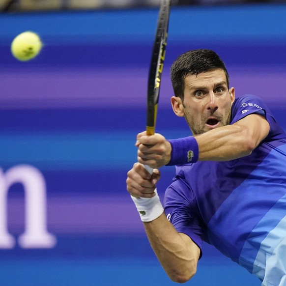 Novak Djokovic, of Serbia, hits a backhand to Matteo Berrettini, of Italy, during the quarterfinals of the U.S. Open tennis tournament Wednesday, Sept. 8, 2021, in New York. (AP Photo/Frank Franklin I ...