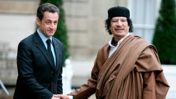 FILE - French President Nicolas Sarkozy, left, greets Libyan leader Col. Moammar Gadhafi upon his arrival on Dec. 10 2007 at the Elysee Palace, in Paris. (AP Photo/Francois Mori, File)
Nicolas Sarkozy ...