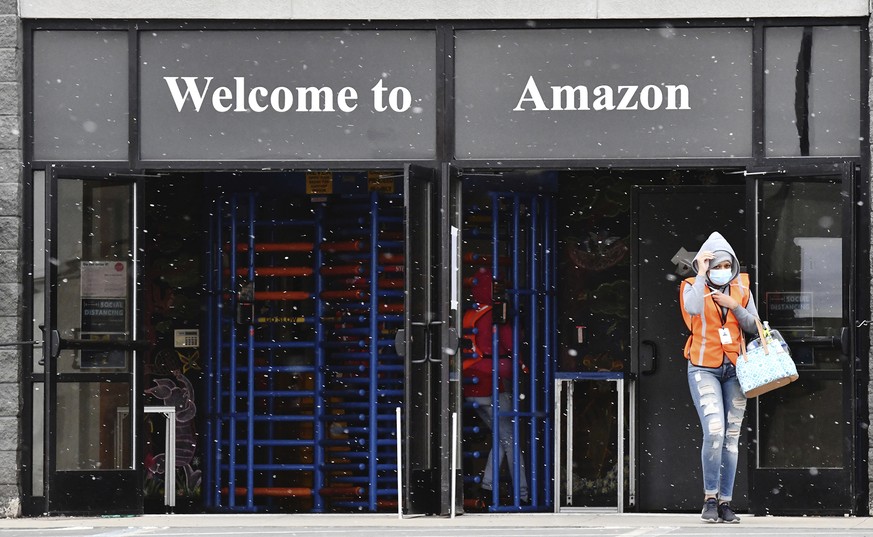 An employee leaves the Amazon fulfillment center at the Humboldt Industrial Park in Hazle Township, Pa. Friday, April 10, 2020. Workers have launched an online petition to temporarily close the facili ...