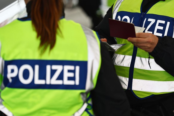 epa12082922 German police officers check papers at a checkpoint near the border with Austria, in Kiefersfelden, Germany, 08 May 2025. The new German interior minister said the country will increase co ...