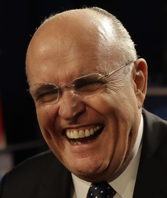 Former New York mayor Rudi Guliani laughs while speaking to guests before the third debate between Democratic presidential nominee Hillary Clinton and Republican presidential nominee Donald Trump duri ...