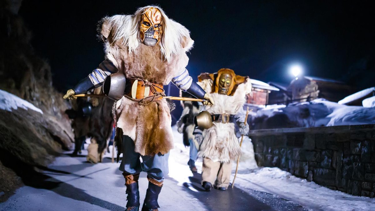 "Tschaeggaettae", masked participants wearing large fur outfits, parade in the streets of the village of Blatten in the Loetschental valley, southwestern Switzerland, late Thursday, February ...