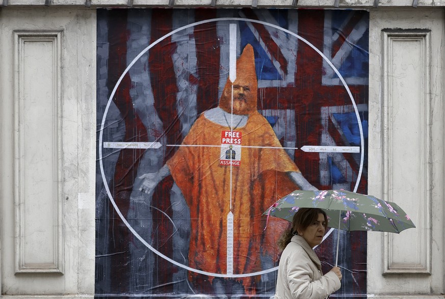 FILE - In this Monday Oct. 21, 2019 file photo a pedestrian passes street art depicting Julian Assange near Westminster Magistrates&#039; Court in London where Assange is expected to appear as he figh ...