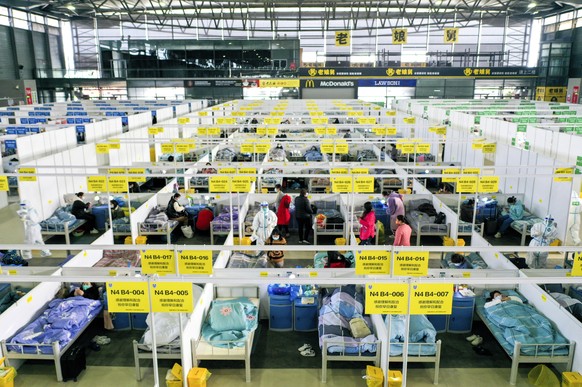 In this photo released by China&#039;s Xinhua News Agency, people with mild and symptomatic cases of COVID-19 quarantine at the Shanghai New International Expo Center in Shanghai, Friday, April 1, 202 ...