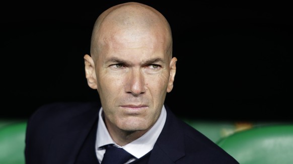 FILE - In this In this file photo dated March 8, 2020, Real Madrid&#039;s head coach Zinedine Zidane sits at the bench during La Liga soccer match in Seville, Spain. Zinedine Zidane is again stepping  ...