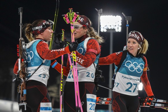 Swiss teammates Lena Haecki (L-R), Irene Cadurisch and Elisa Gasparin talk after the women&#039;s 12.5-kilometer mass start biathlon at the 2018 Winter Olympics in Pyeongchang, South Korea, Saturday,  ...