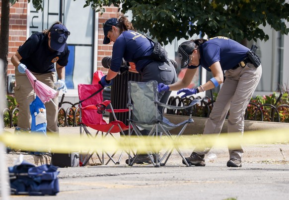 epaselect epa10053740 Law enforcement officers continue the investigation into the scene of a mass shooting at a 4th of July celebration and parade in Highland Park, Illinois, USA, 05 July 2022. A gun ...