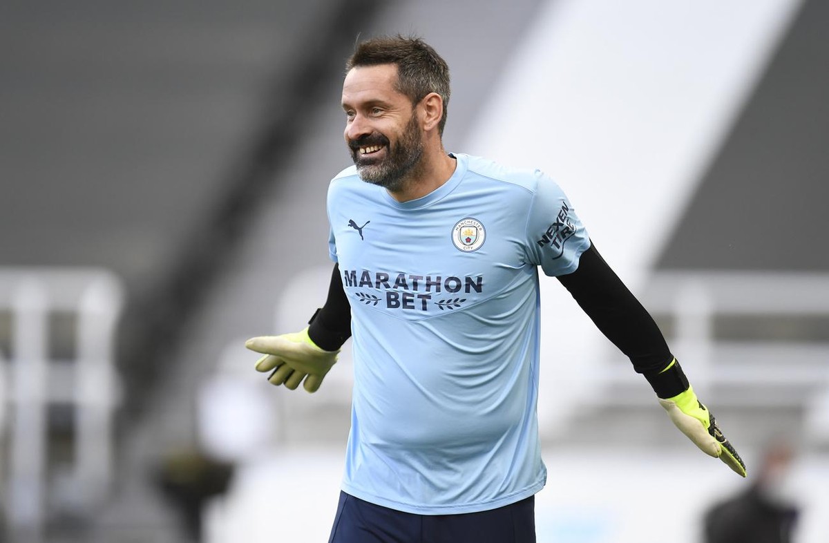 Manchester City's goalkeeper Scott Carson warms up prior to the English Premier League soccer match between Newcastle United and Manchester City at St James' Park stadium, in Newcastle, Engl ...