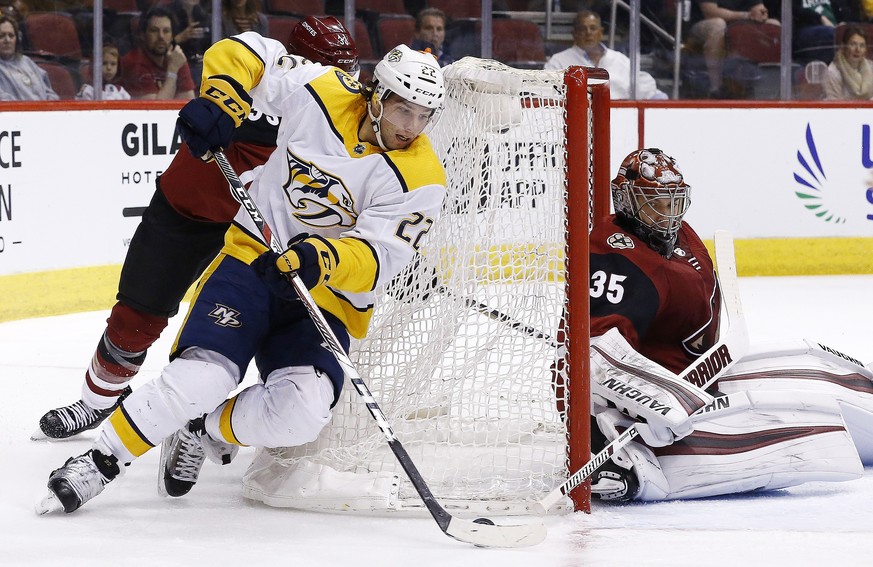 Nashville Predators left wing Kevin Fiala (22) tries to shoot against Arizona Coyotes goaltender Darcy Kuemper (35) during the first period of an NHL hockey game Thursday, March 15, 2018, in Glendale, ...