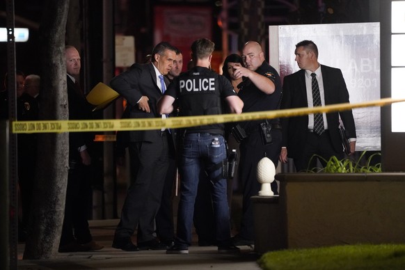 Investigators gather outside an office building where a shooting occurred in Orange, Calif., Wednesday, March 31, 2021. The shooting killed several people, including a child, and injured another perso ...