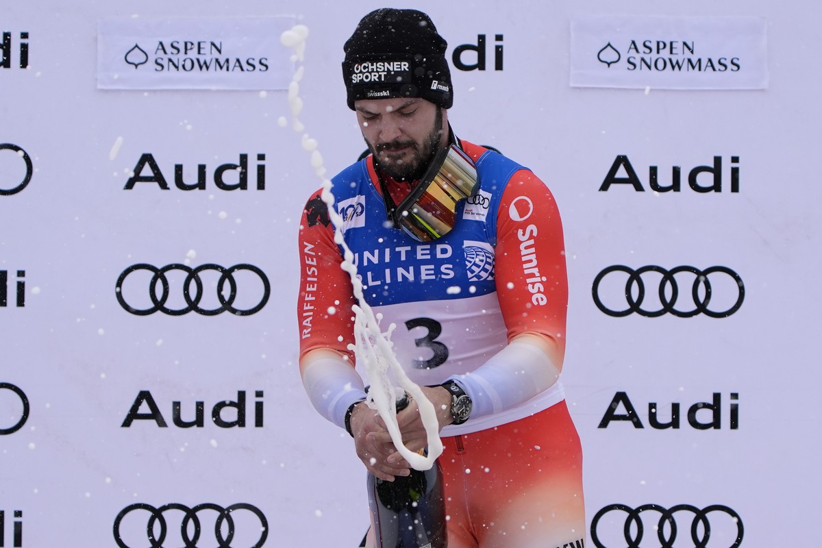 First place finisher Switzerland's Loic Meillard celebrates with champagne after a men's World Cup slalom skiing race Sunday, March 3, 2024, in Aspen, Colo. (AP Photo/John Locher)