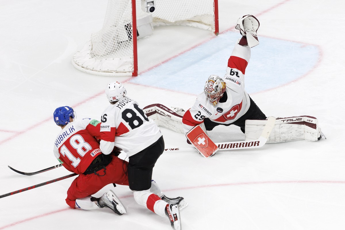 epa10644594 Switzerland's goaltender Robert Mayer (R) saves a shot from Czech Republic's forward Dominik Kubalik (L) during the group B match between Czech Republic and Switzerland at the II ...