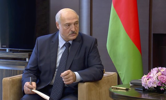 In this photo taken from video and released by Russian Presidential Press Service, Belarusian President Alexander Lukashenko talks with Russian President Vladimir Putin during their meeting in the Boc ...