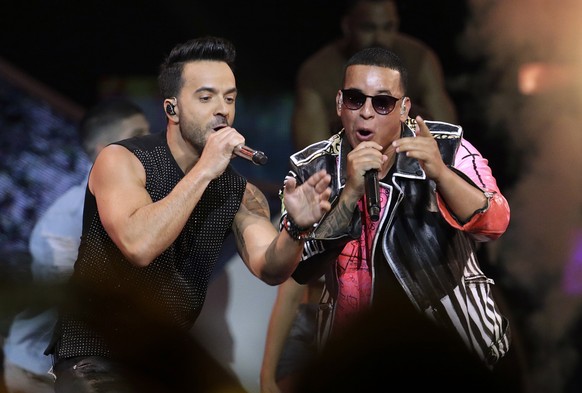 FILE - In this April 27, 2017, file photo, singers Luis Fonsi, left, and Daddy Yankee perform during the Latin Billboard Awards in Coral Gables, Fla. “Despacito” dominated 2017, but it’s still bringin ...