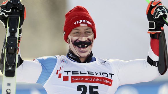 Switzerland&#039;s Justin Murisier sports a face mask as he celebrates his third place in a alpine ski, men&#039;s World Cup giant slalom in Alta Badia, Italy, Sunday, Dec.20, 2020. (AP Photo/Marco Tr ...