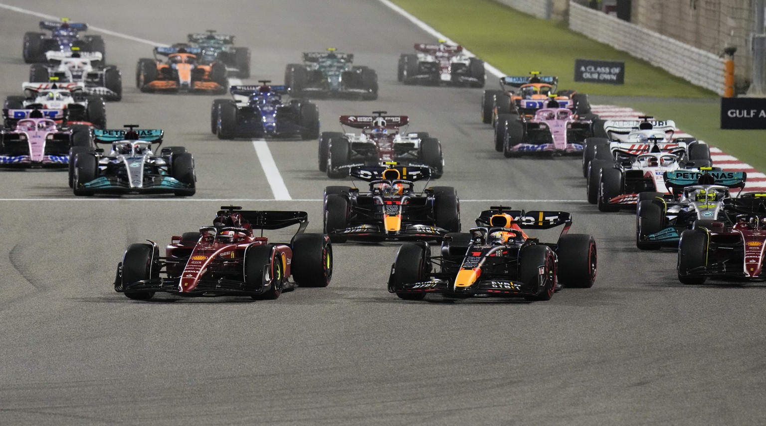 Ferrari driver Charles Leclerc of Monaco, left, and Red Bull driver Max Verstappen of the Netherlands lead at the start during the Formula One Bahrain Grand Prix it in Sakhir, Bahrain, Sunday, March 2 ...