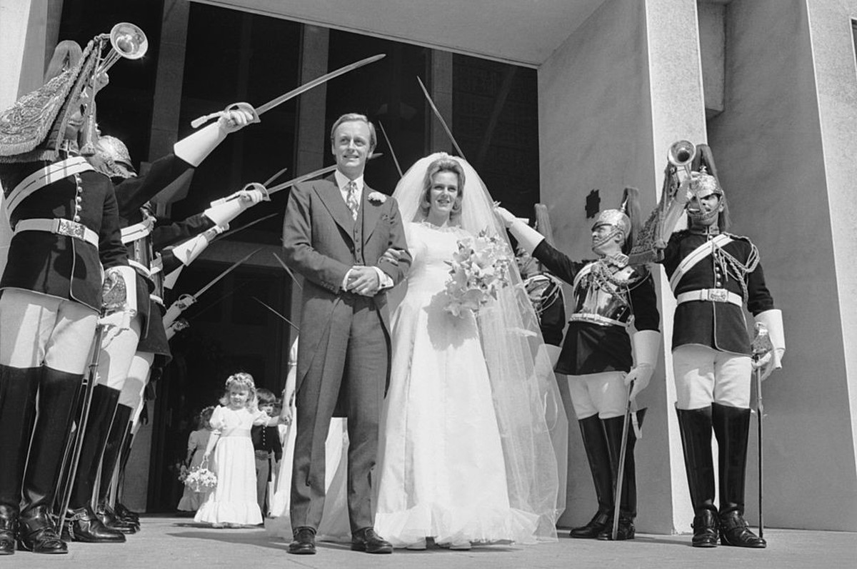 Camilla Shand and Major Andrew Parker-Bowles pass through the Guard of Honour after their wedding at the Guards Chapel, Wellington Barracks, 4th July 1973. (Photo by Wood/Express/Hulton Archive/Getty  ...