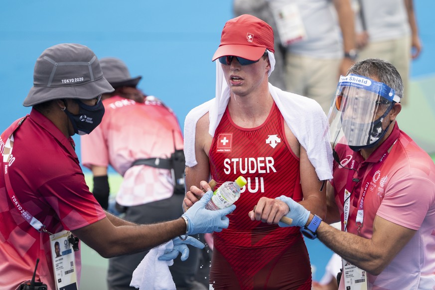 Medical staff members take care of Switzerland&#039;s Max Studer in the finish area during the men&#039;s Individual Triathlon competition at the 2020 Tokyo Summer Olympics in Tokyo, Japan, on Monday, ...