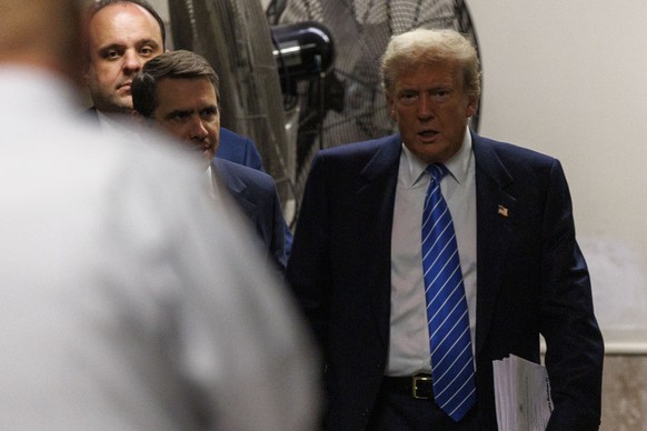 epa11337667 Former US President Donald Trump and lawyer Todd Blanche return to his criminal trial after a short break at New York State Supreme Court in New York, New York, USA, 13 May 2024. Trump is  ...