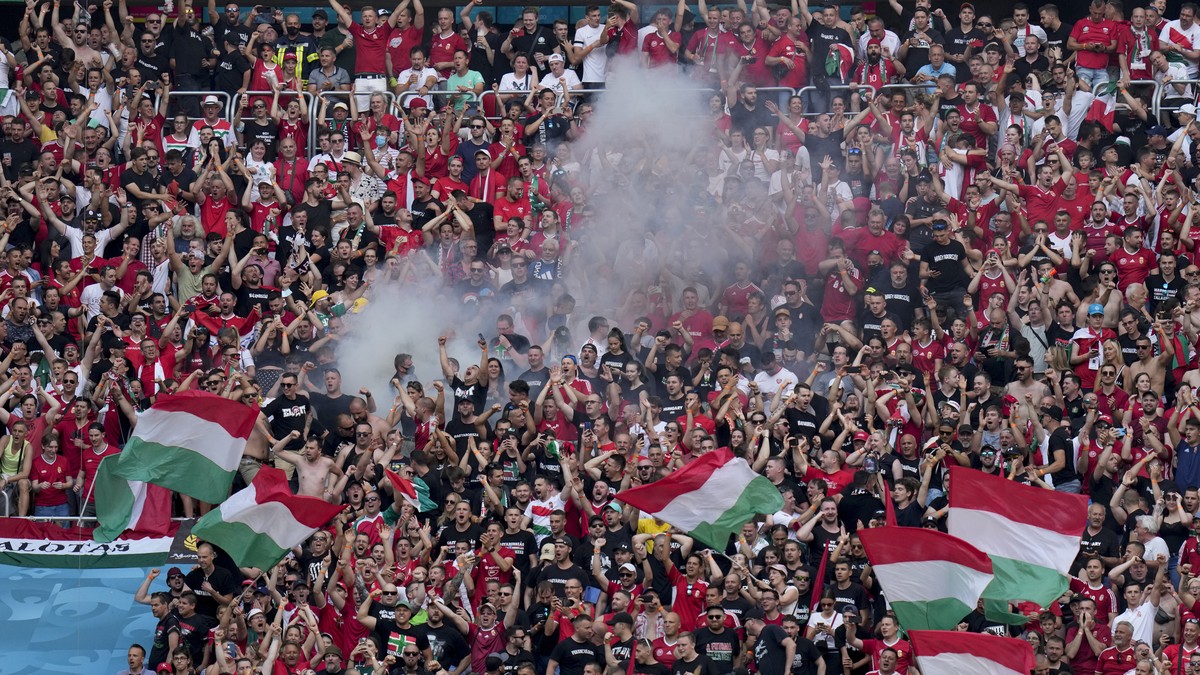 Hungarian fans celebrate after Attila Fiola scored his side's opening goal, during the Euro 2020 soccer championship group F match between Hungary and France, at the Ferenc Puskas stadium in Buda ...