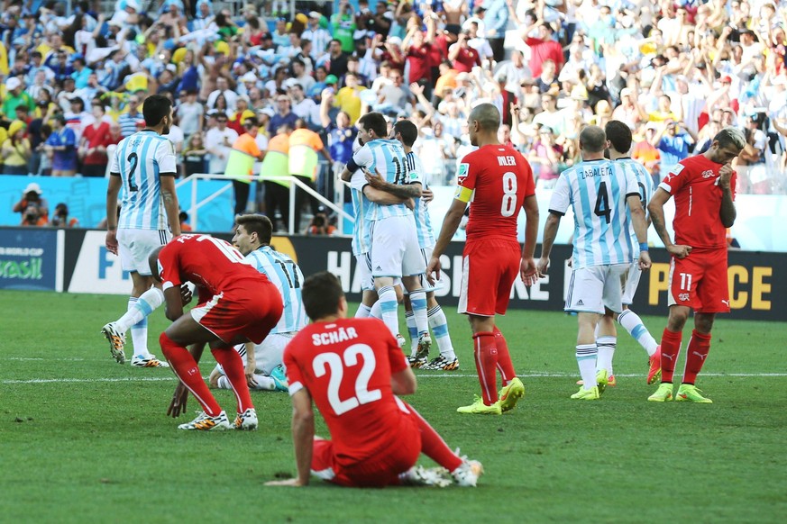 Argentina celebrates as Switzerland s players regrets after their victory 1-0,, during a match for the 8t hs. final of the football World Cup Brazil 2014, at Corinthians Arena Stadium, in Sao Paulo, B ...