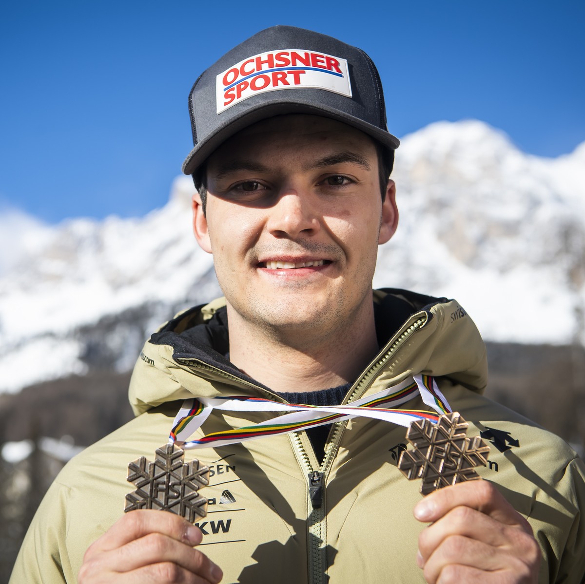 Loic Meillard of Switzerland poses with the Bronze medal for Parallel race and the Bronze medal for Alpine Combined race at the 2021 FIS Alpine Skiing World Championships in Cortina d'Ampezzo, It ...