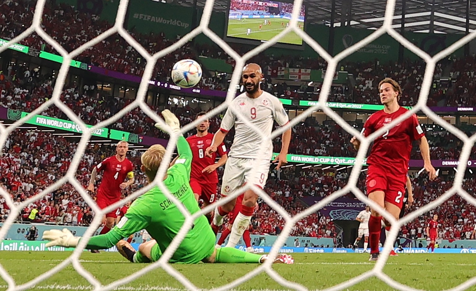 epa10320481 Goalkeeper Kasper Schmeichel of Denmark makes a safe against Issam Jebali (C) of Tunisia during the FIFA World Cup 2022 group D soccer match between Denmark and Tunisia at Education City S ...