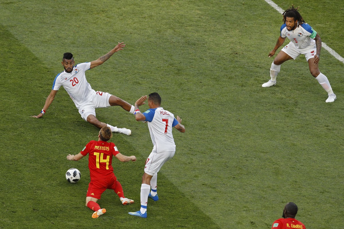 Belgium's Dries Mertens, left, is tackled by Panama's Blas Perez, second right, during the group G match between Belgium and Panama at the 2018 soccer World Cup in the Fisht Stadium in Sochi ...