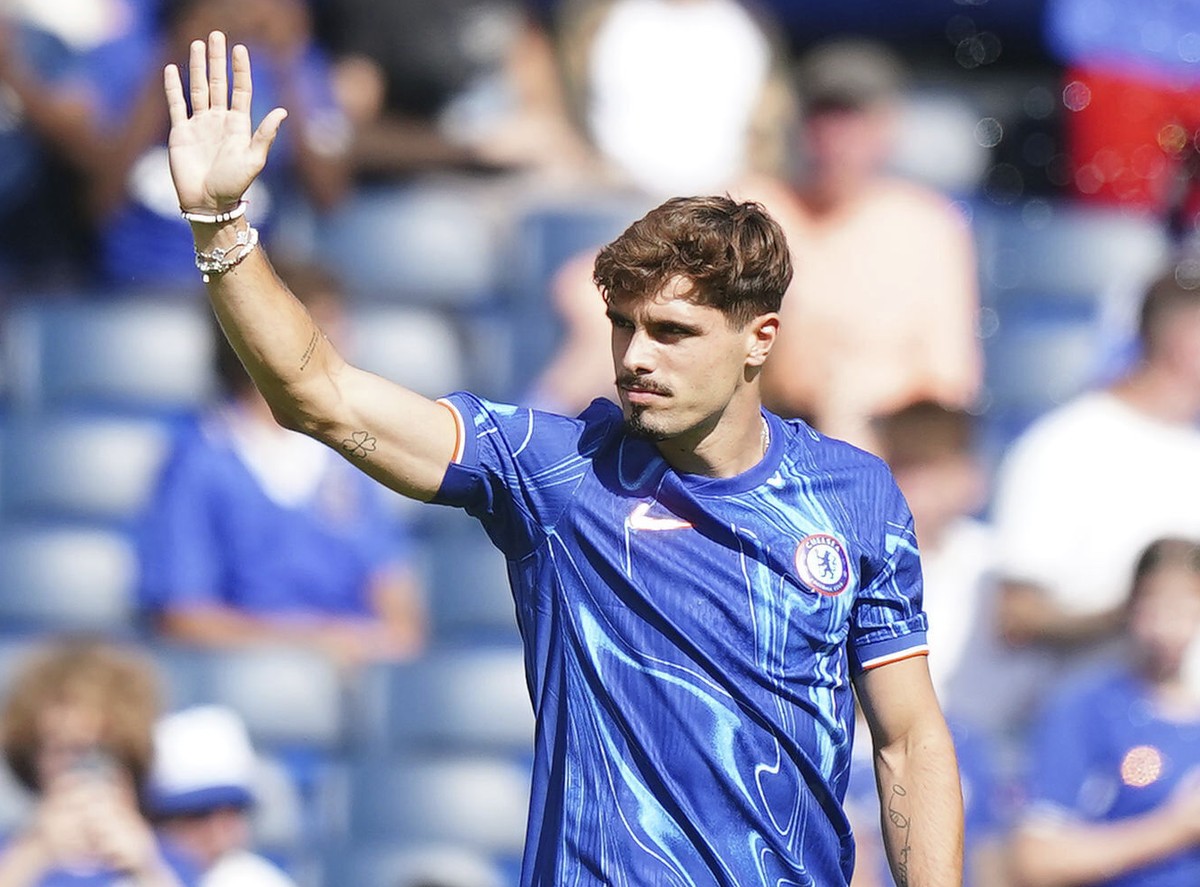 Chelsea's new signing Pedro Neto waves to the crowd during the pre-season friendly match at Stamford Bridge, London on Sunday, Aug. 11, 2024. (Zac Goodwin/PA via AP)