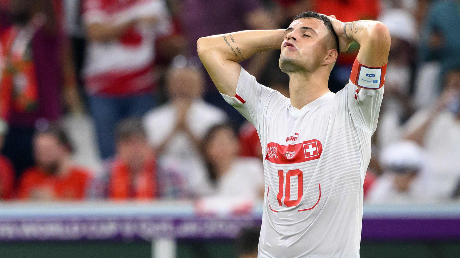 Switzerland&#039;s midfielder Granit Xhaka, right, and Switzerland&#039;s midfielder Denis Zakaria, left, react after the elimination during the FIFA World Cup Qatar 2022 round of 16 soccer match betw ...