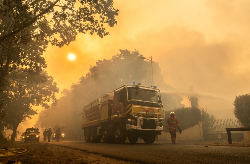 epa13129766 A handout photo made available by Sdis33 (Gironde Departmental Fire and Rescue Service) shows a firefighting crew being deployed to battle a wildfire spreading in Lege-Cap-Ferret, south-we ...