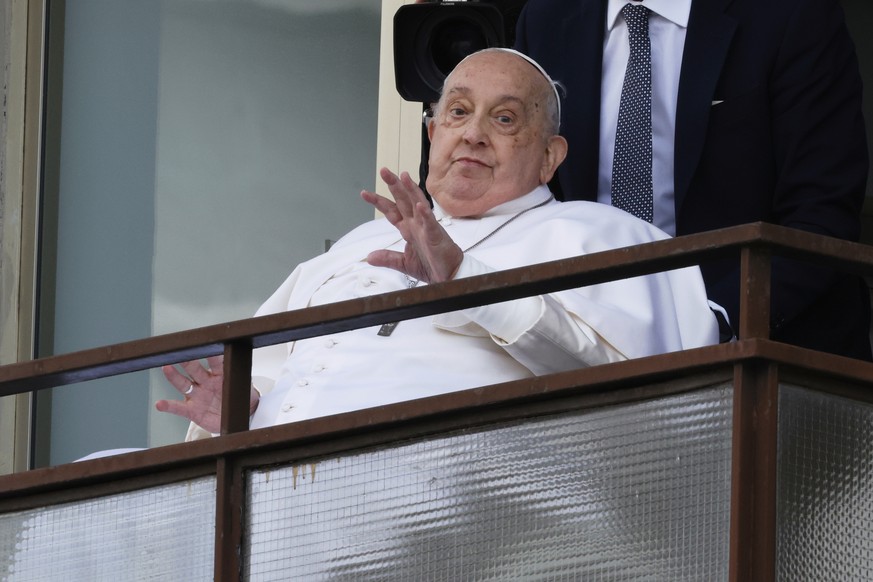 Pope Francis appears at a window of the Agostino Gemelli Polyclinic in Rome, Sunday, March 23, 2025, where he has been treated for bronchitis and bilateral pneumonia since Feb. 14. (AP Photo/Riccardo  ...