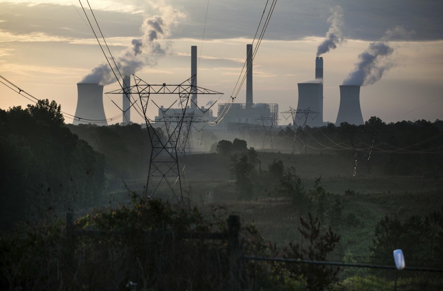 The coal-fired Plant Scherer, one of the nation's top carbon dioxide emitters, stands in the distance in Juliette, Ga., Saturday, June, 3, 2017. U.S. President Donald Trump declared Thursday he w ...