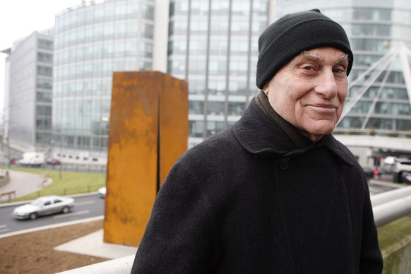 FILE - Famed American sculptor Richard Serra poses in front of &quot;Slat,&quot; a 1984 steel sculpture, after its reinstallation in La Defense, west of Paris, Dec. 15, 2008. Serra, known for turning  ...