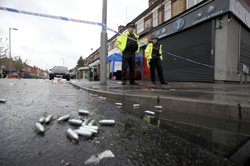 Police officers stand at the cordoned off area in Claremont Road in Manchester after a shooting Sunday, Aug. 12, 2018. Police in Manchester say some people have been hospitalized as the result of a sh ...