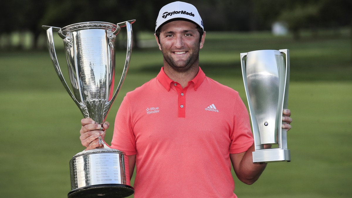 epa08636671 Jon Rahm of Spain poses for photographs with the Western Golf Association and the BMW Championship trophies after winning the 2020 BMW Championship held at the Olympia Fields Country Club  ...