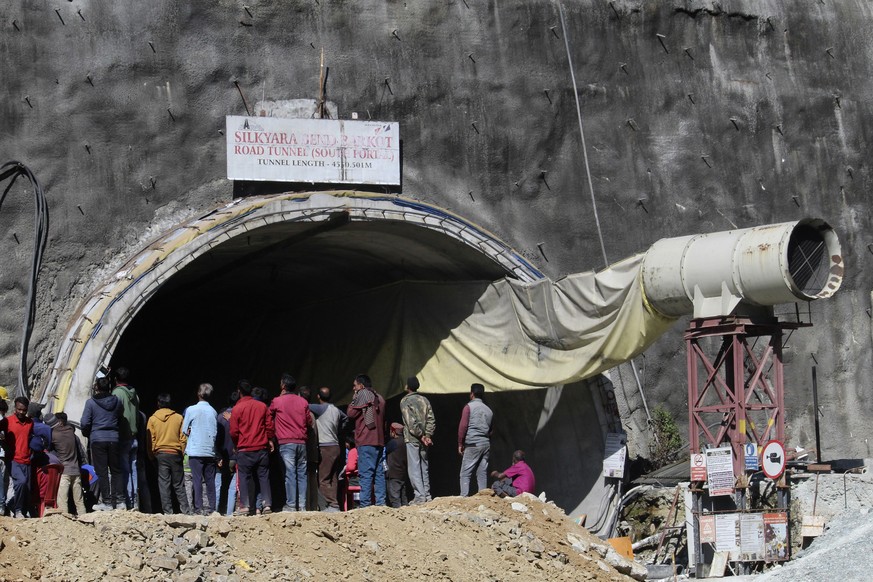 People watch rescue and relief operations at the site of an under-construction road tunnel that collapsed in the mountainous state of Uttarakhand, India, on Wednesday, November 15, 2023.  Rescuers tried...