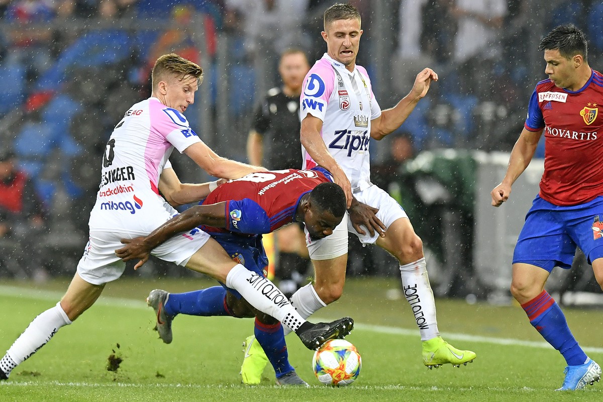 Basel's Afimico Pululu, right, fights for the ball against LASK's Philipp Wiesinger, left, during the UEFA Champions League third qualifying round first leg match between Switzerland's  ...