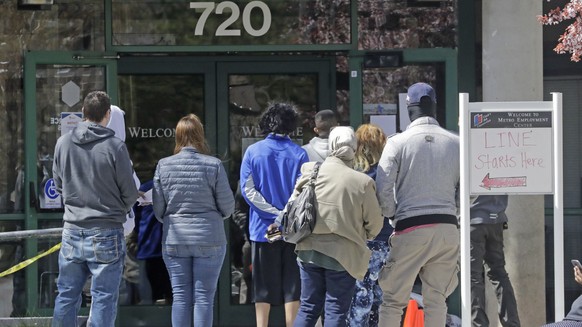 FILE - In this April 13, 2020, file photo, people line up outside the Utah Department of workforce Services, in Salt Lake City. The number of people requesting unemployment assistance in Utah last wee ...