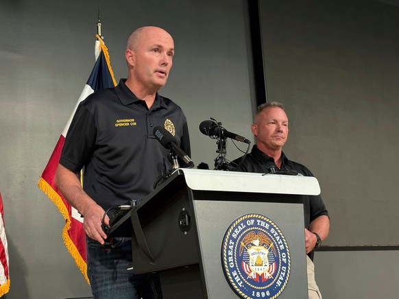 Utah Gov. Spencer Cox, left, speaks with Utah Valley University Chief of Police Jeff Long, right, at a press conference at the Keller Building on the Utah Valley University campus after Charlie Kirk w ...