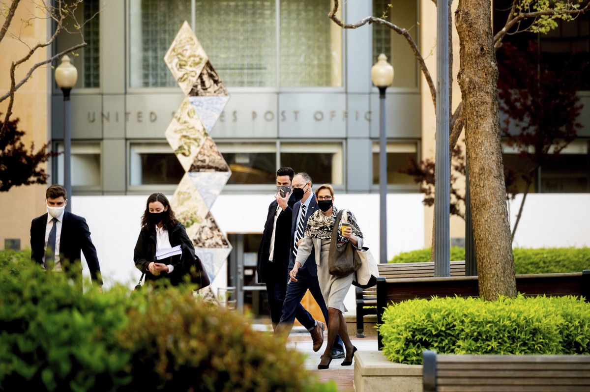 Epic Games CEO Tim Sweeney, second right, approaches the Ronald V. Dellums building in Oakland, Calif., to attend his company's federal court case against Apple on Monday, May 3, 2021. Epic, make ...