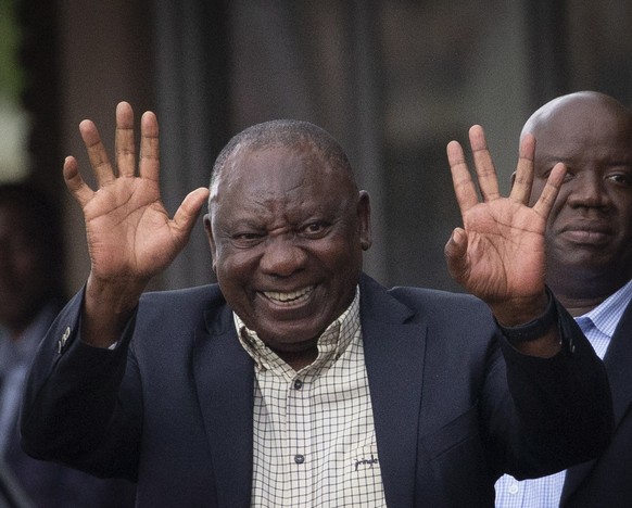 epa10349170 South African President Cyril Ramaphosa waves as he departs the National Executive Committee of the African National Congress (ANC NEC) meeting concerning his political future, during a AN ...