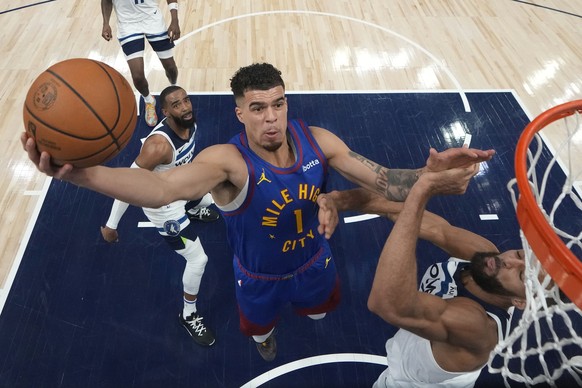 Denver Nuggets forward Michael Porter Jr. (1) shoots as Minnesota Timberwolves center Rudy Gobert, right, defends during the first half of Game 3 of an NBA basketball second-round playoff series Frida ...