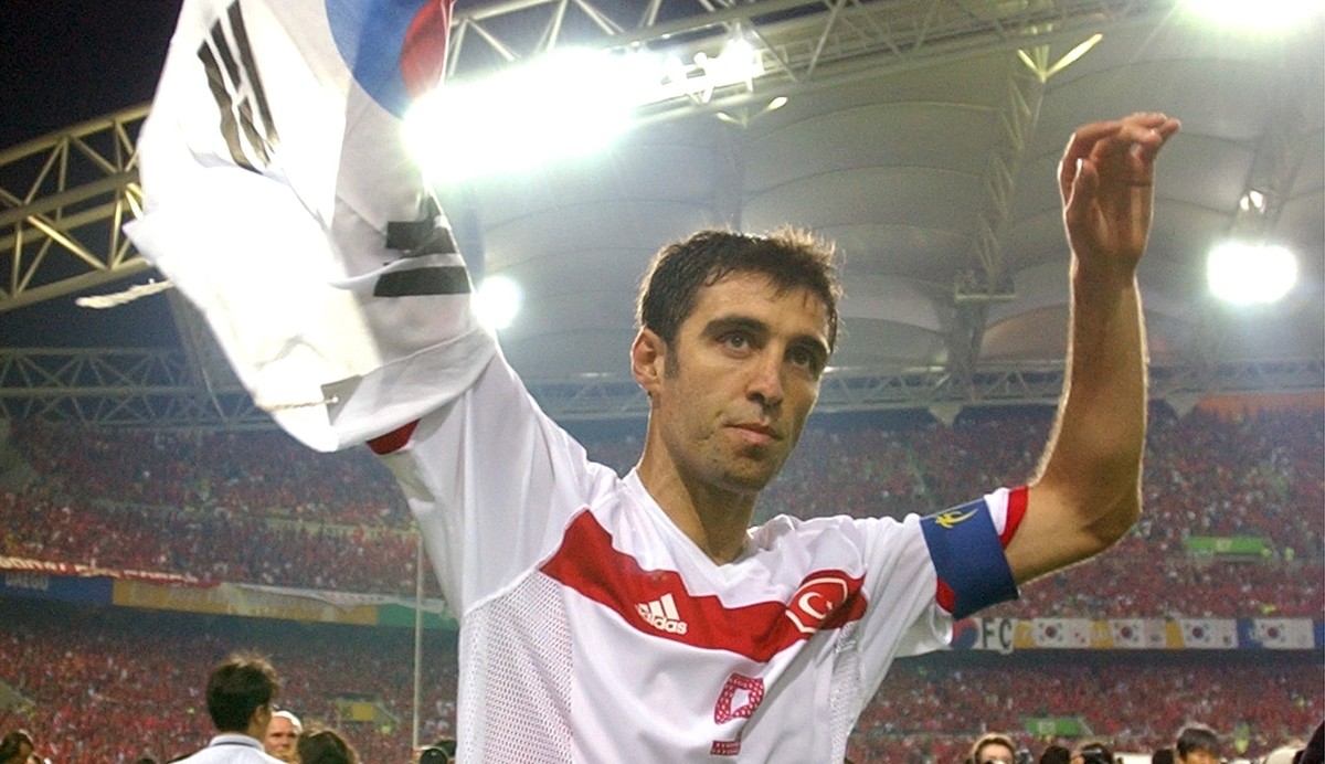 FILE - In this Saturday, June 29, 2002, file photo, Turkey's Hakan Sukur holds a South Korean flag at the end of the 2002 World Cup third place playoff soccer match between South Korea and Turkey ...