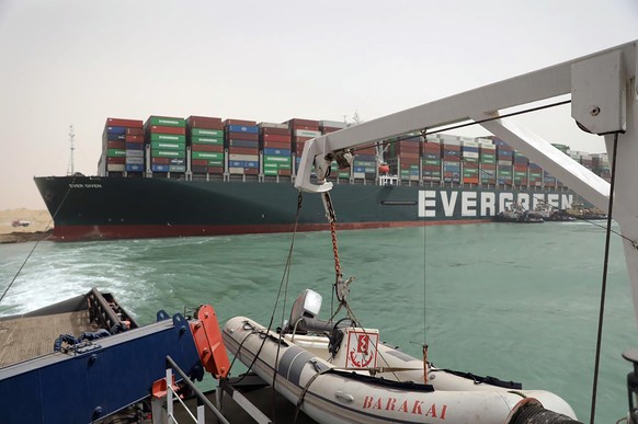 This photo released by the Suez Canal Authority on Thursday, March 25, 2021, shows the Ever Given, a Panama-flagged cargo ship, after it become wedged across the Suez Canal and blocking traffic in the ...