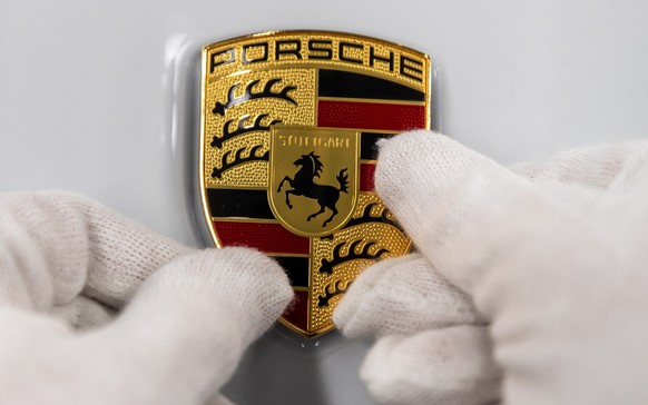 epa08271931 A view of a Logo at the production of Taycan electric sports cars at an assembly line at the German car manufacturer Porsche in Stuttgart, Germany, 05 March 2020. Porsche AG is a listed Ge ...