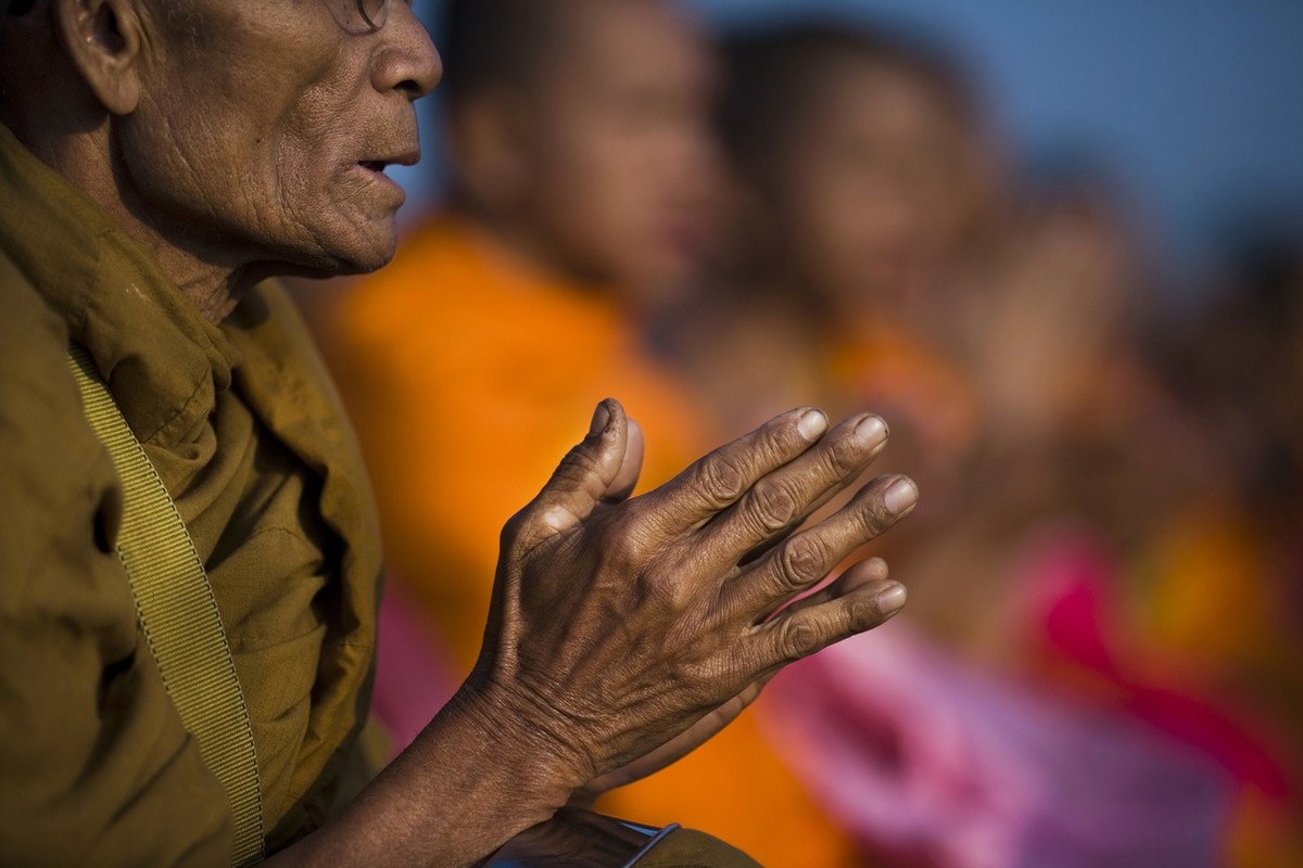 Thai Buddhist monks chant prayers as more than 10,000 gathered near Lopburi, Thailand, Saturday, Dec. 20, 2008, to pray for peace. Thailand is still experiencing violence in the south while political  ...