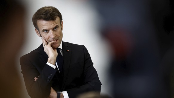 French President Emmanuel Macron listens to schoolchildren in a classroom during a prevention session on the papillomavirus (HPV infection) as he visits the College Jean Lartaut Middle School in Jarna ...