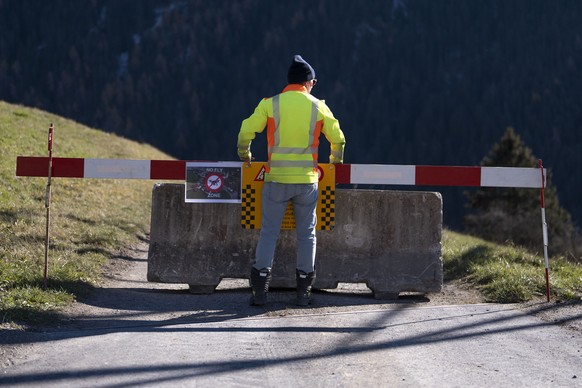 epa11725732 Signs and barriers block the road to Brienz Brinzauls, Switzerland, 17 November 2024. A stream of debris almost reached the village on 15 June 2024, which had been evacuated since 12 May 2 ...