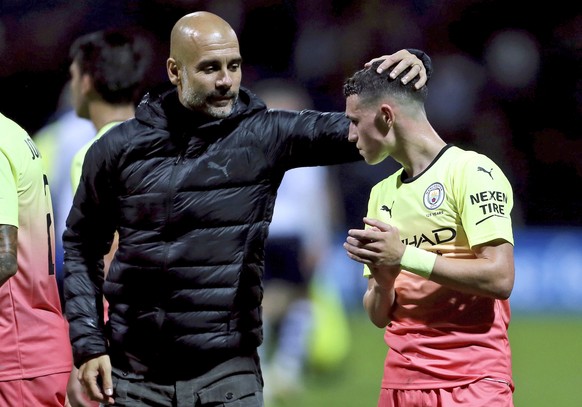 Manchester City manager Pep Guardiola, left, congratulates Phil Foden after an English League Cup soccer match between between Manchester City and Preston North End, Tuesday, Sept. 24, 2019, at Deepda ...